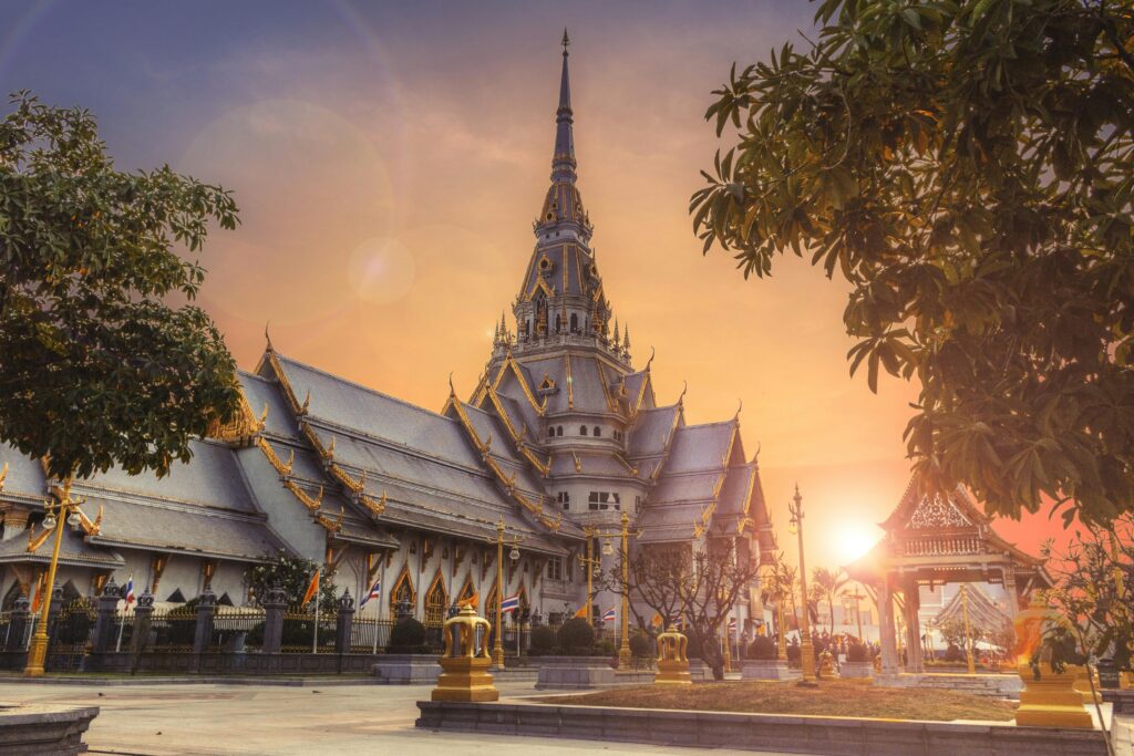 Scenic view of Wat Sothonwararam Temple during sunset in Thailand, capturing its beautiful architecture.